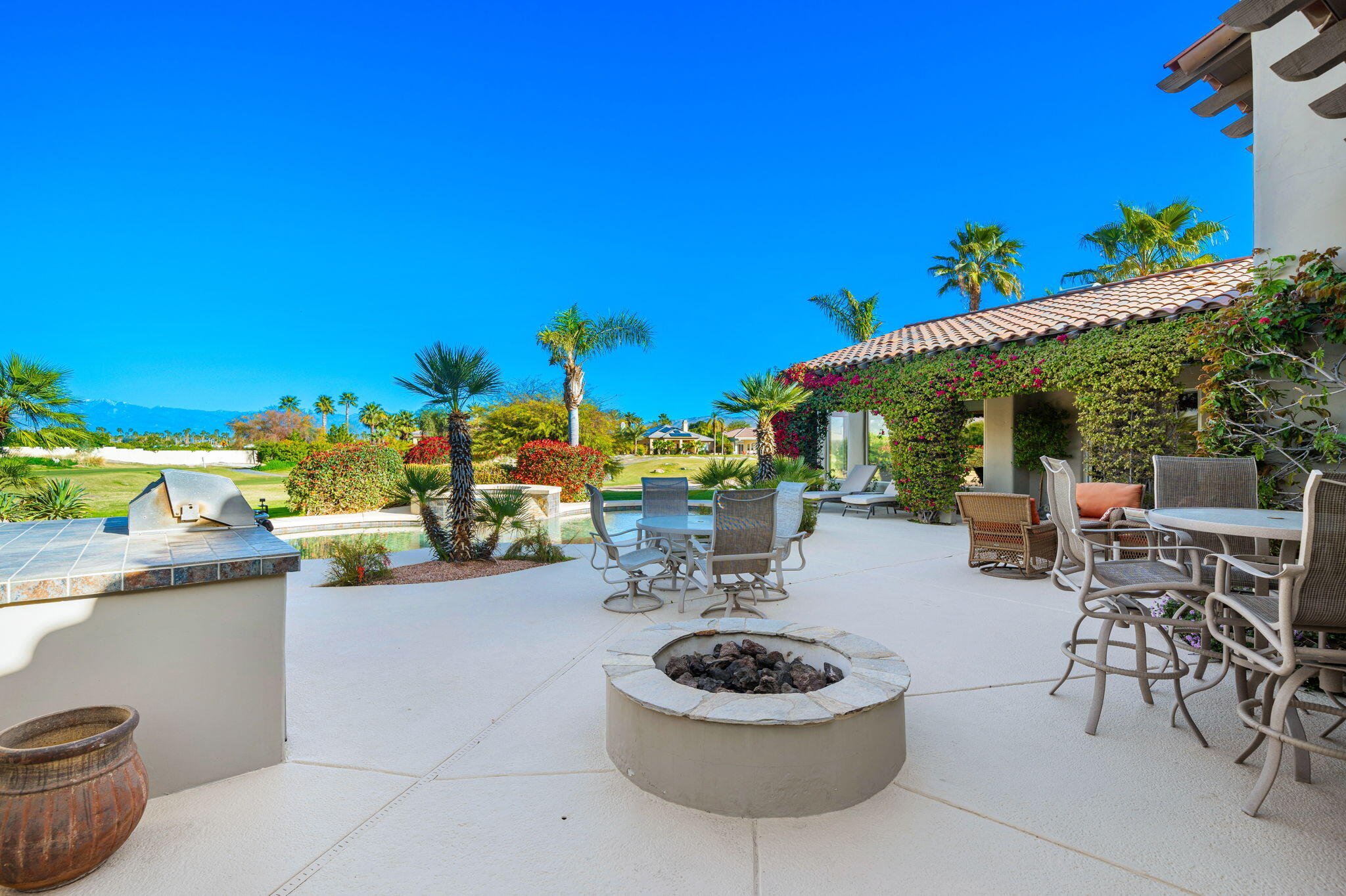 325 Loch Lomond Road Rancho Mirage, CA 92270 - Photo 36 of 49 a swimming pool with outdoor seating and plants