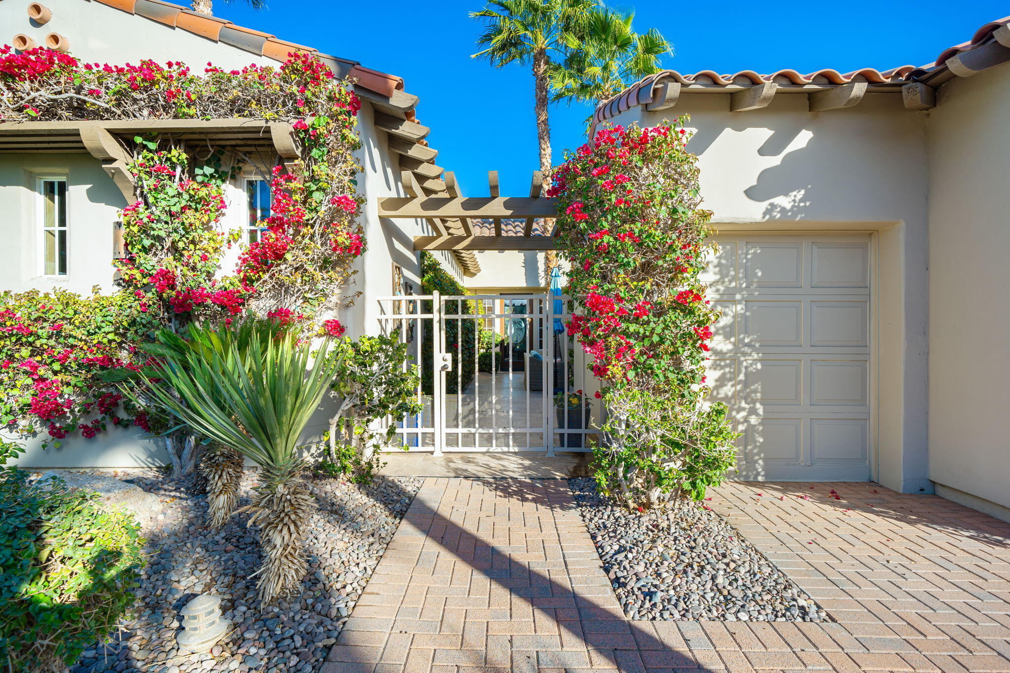 325 Loch Lomond Road Rancho Mirage, CA 92270 - Photo 8 of 49 a potted plant sitting in front of a house