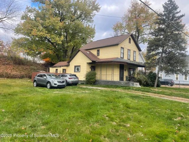 a view of a house with a back yard