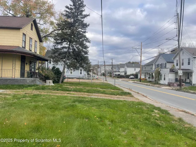 a view of a street with houses on the side