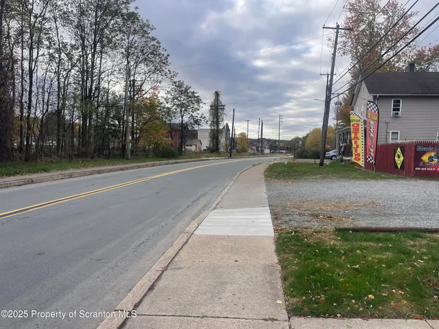 a view of a street with a cars parked in front of it