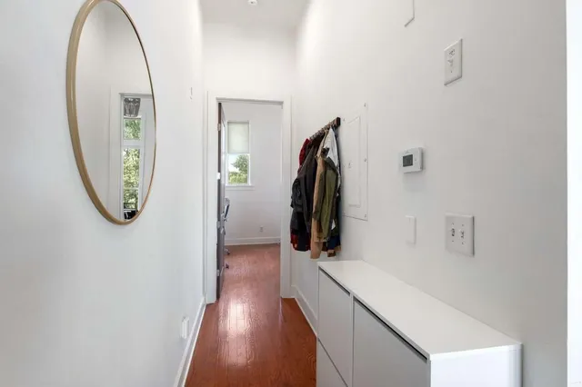 a view of a hallway with wooden floor