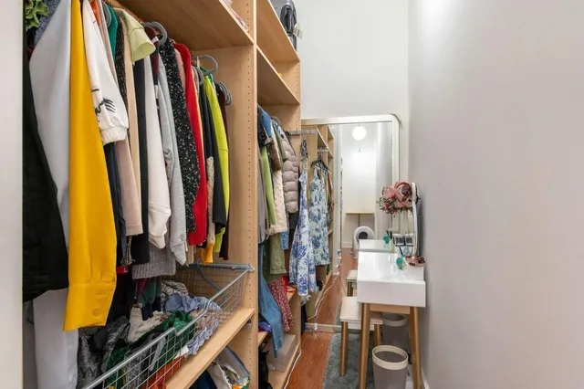 a view of walk in closet with clothes