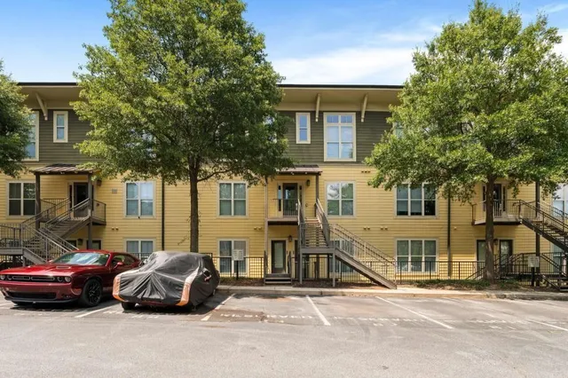 a car parked in front of a white house