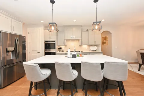 a large kitchen with a table and chairs