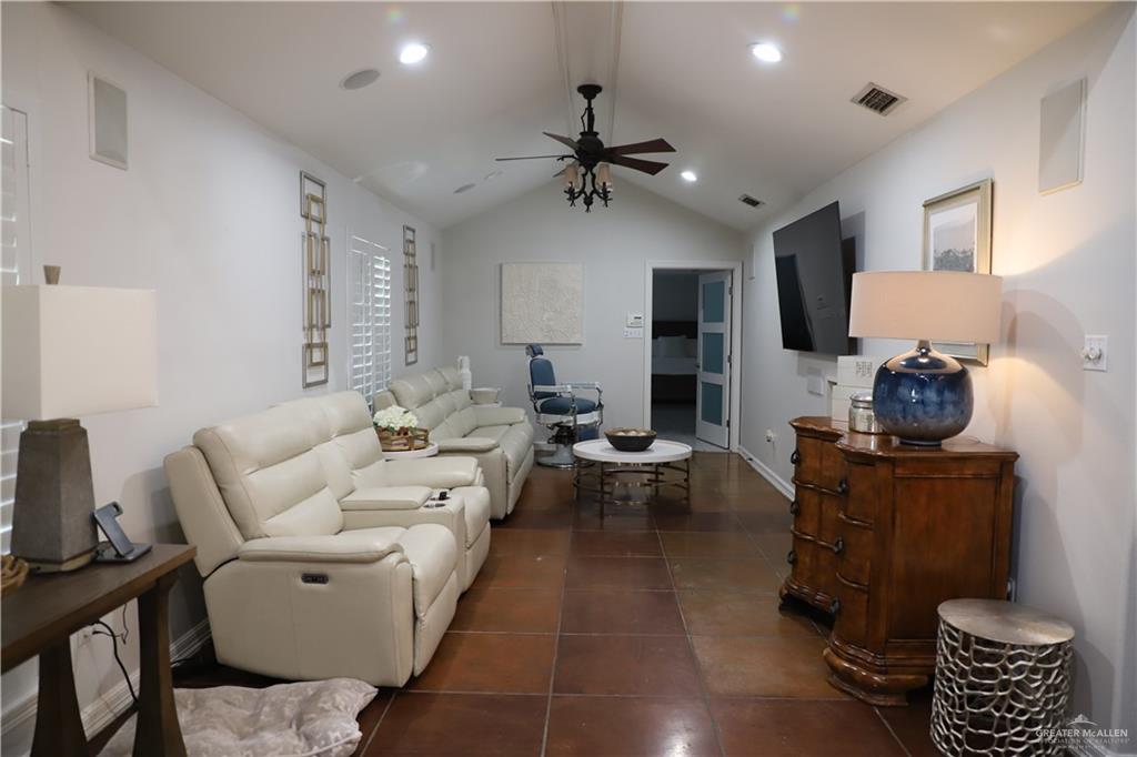 12431 Ware Road Edinburg, TX 78541 - Photo 16 of 37 a living room with furniture a rug and a chandelier