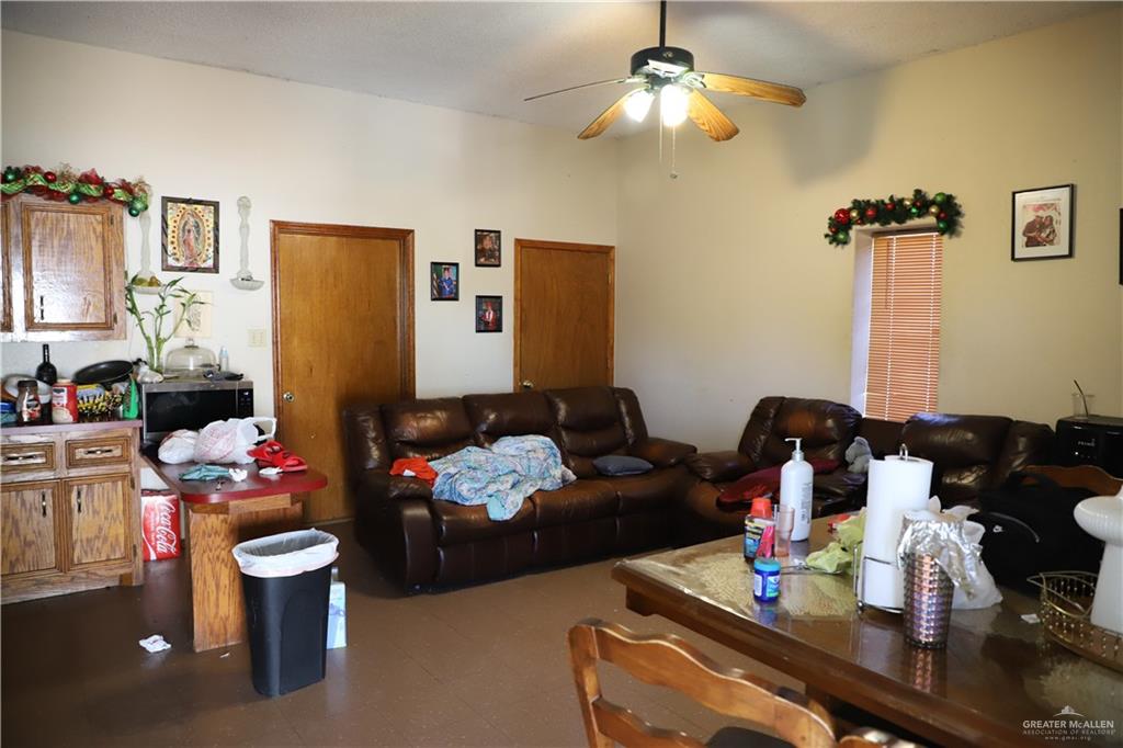 12431 Ware Road Edinburg, TX 78541 - Photo 36 of 37 a living room with furniture and a chandelier