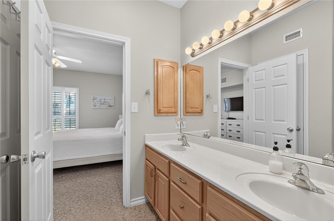 14427 Compass Street, Unit B12 Corpus Christi, TX 78418 - Photo 21 of 40 Primary bathroom includes double sinks and an extr