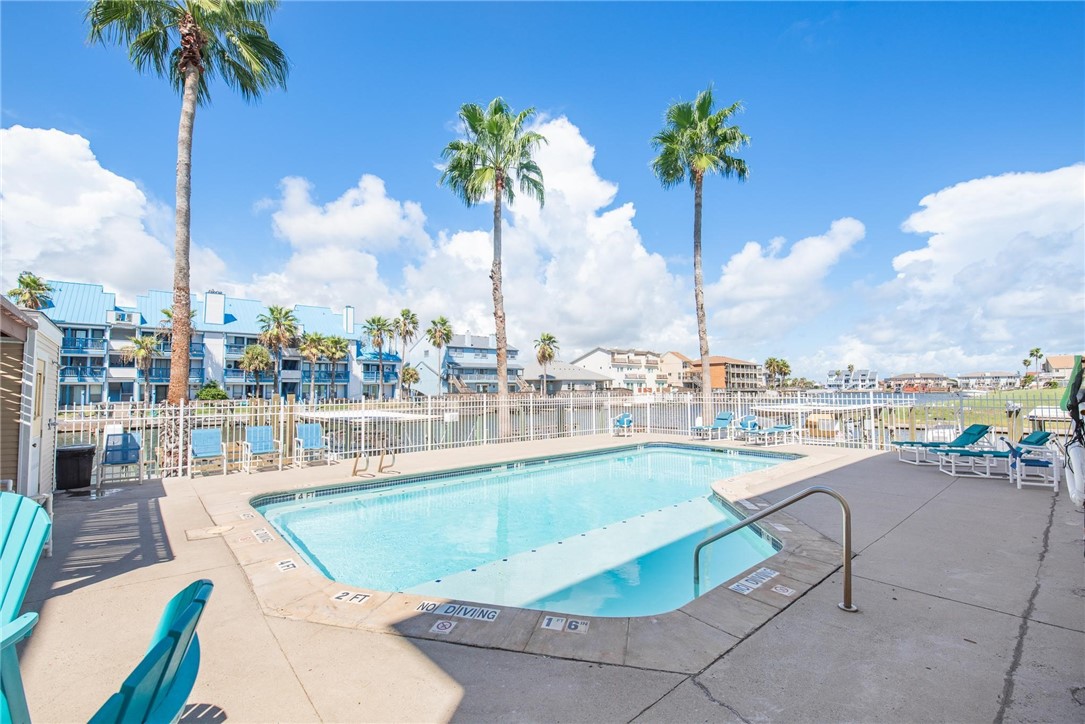 14427 Compass Street, Unit B12 Corpus Christi, TX 78418 - Photo 30 of 40 A beautiful sunny pool with a fantastic canal view