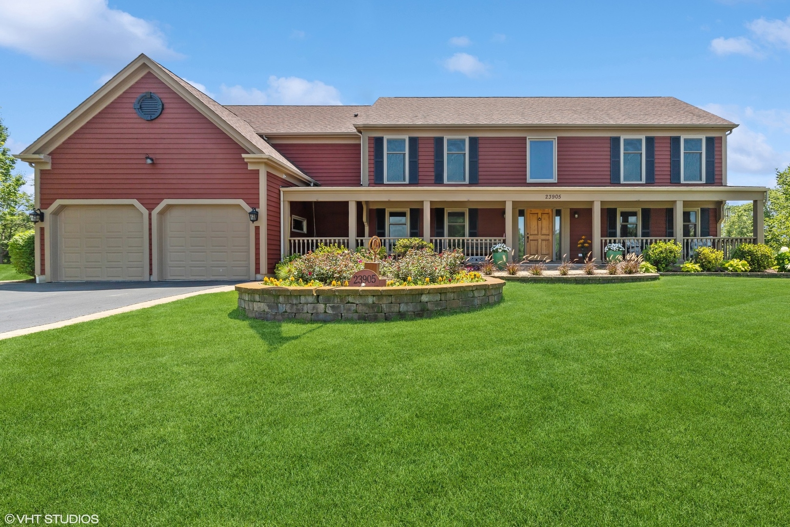 a front view of house with yard and trees in the background