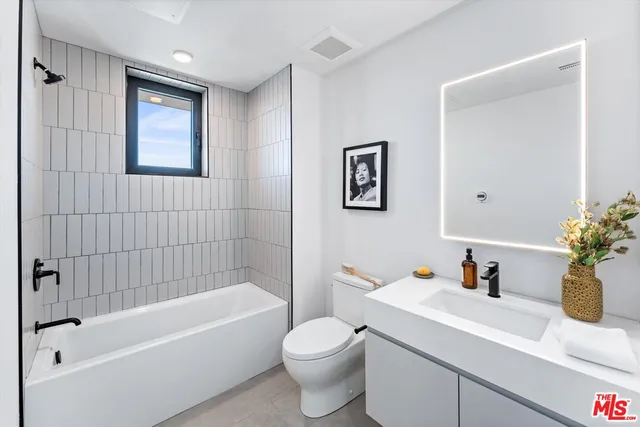 a bathroom with a sink a toilet and a bathtub