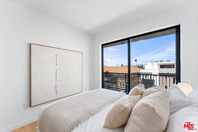 a bed sitting in a bedroom next to a window