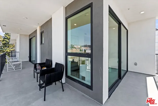 a view of a hallway with furniture and front door