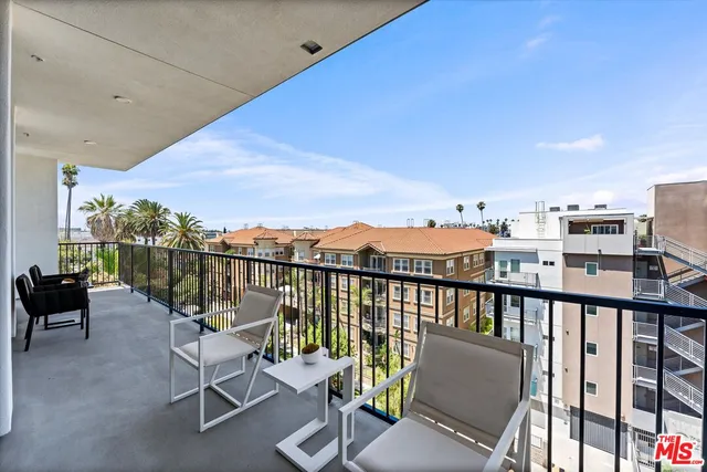 a view of a balcony with chairs