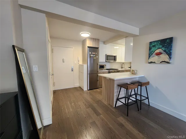 a view of kitchen with cabinets and wooden floor