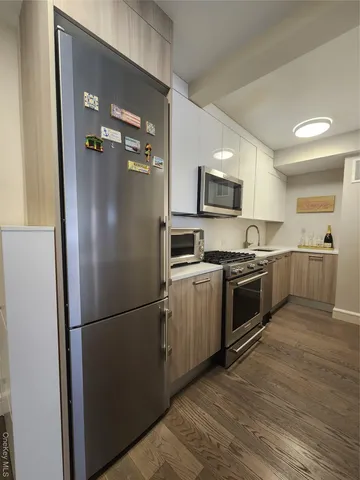 a kitchen with a refrigerator and a stove top oven