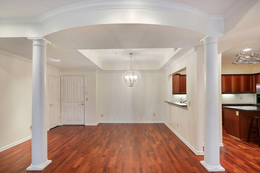 Gleaming hardwoods, a trey ceiling, a new chandelier, and fine molding detail accent the dining area.