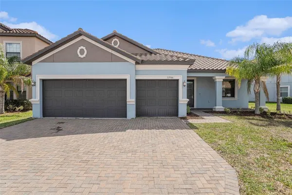 a front view of a house with a yard and garage