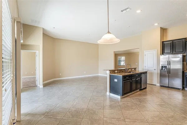 a kitchen with stainless steel appliances granite countertop a stove a refrigerator and a sink