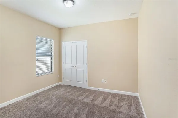 a view of an empty room with windows