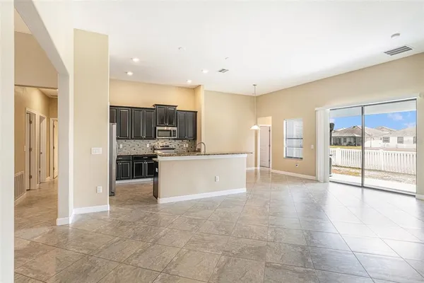 a large kitchen with a large counter top stainless steel appliances