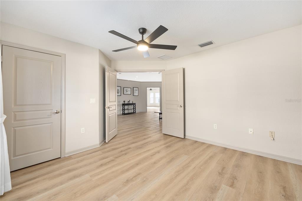 1120 East Highway 316 Citra, FL 32113 - Photo 22 of 61 a view of a livingroom with wooden floor and a ceiling fan