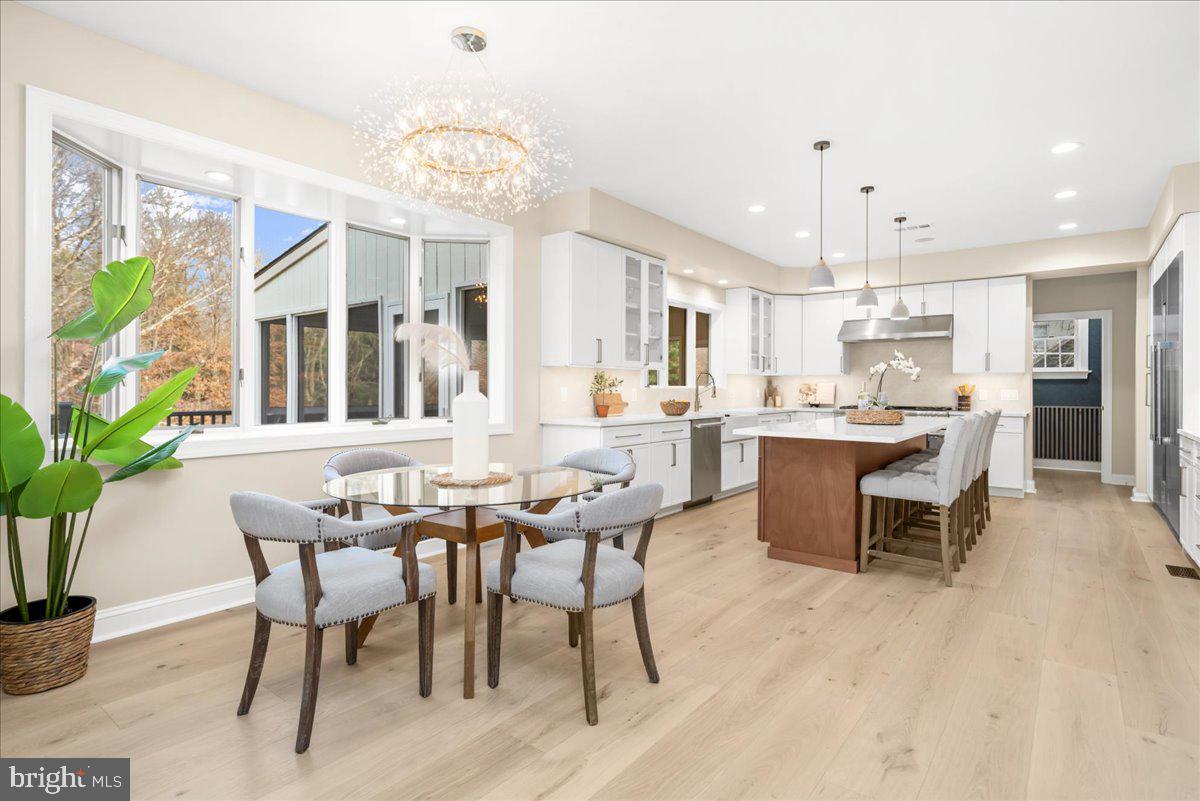4205 Goshen Road Newtown Square, PA 19073 - Photo 26 of 104 a dining room with stainless steel appliances kitchen island granite countertop a table chairs sink and cabinets