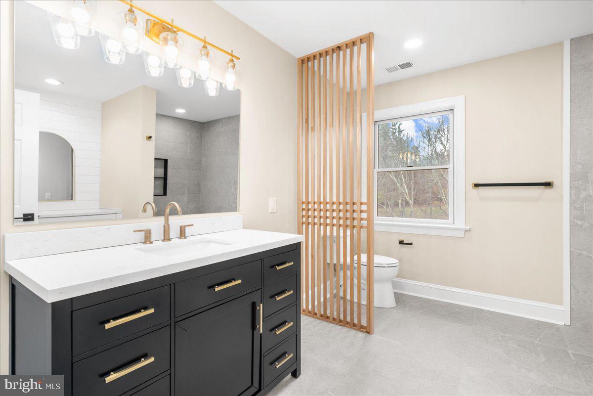 4205 Goshen Road Newtown Square, PA 19073 - Photo 57 of 104 a bathroom with a sink a vanity a mirror and a bathtub next to a window