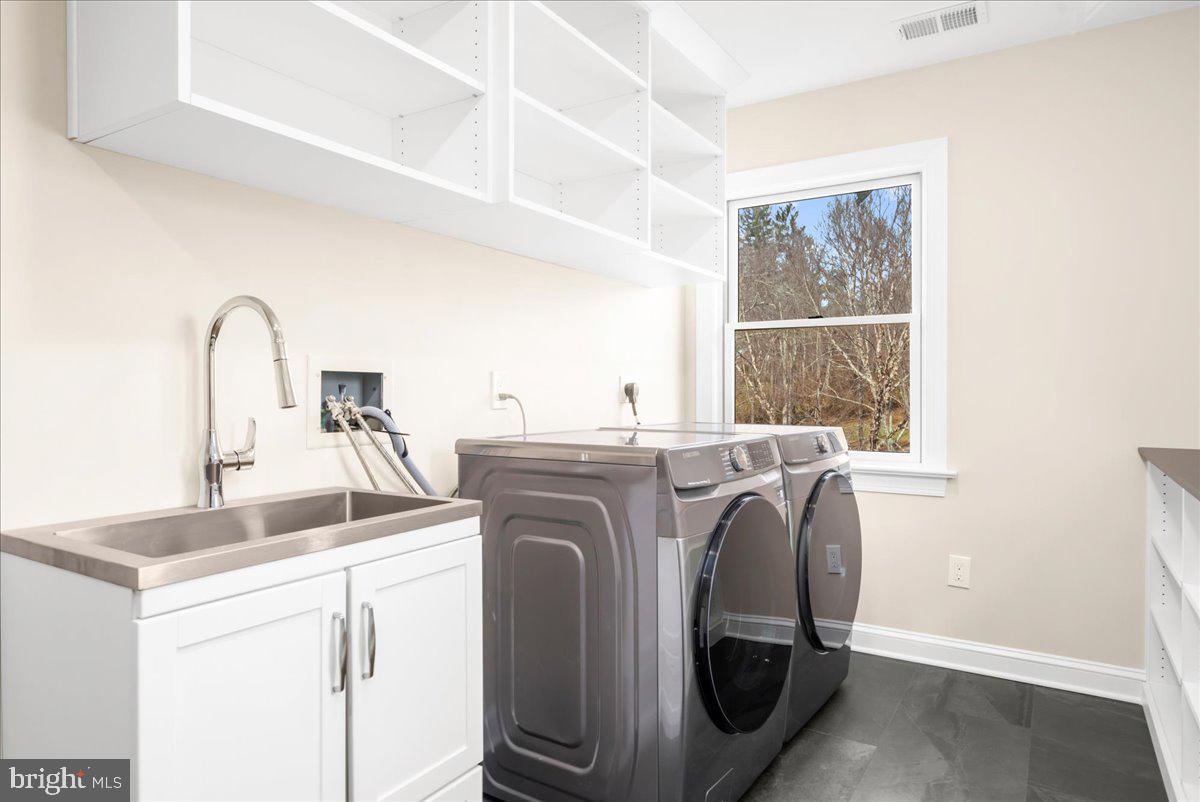 4205 Goshen Road Newtown Square, PA 19073 - Photo 62 of 104 a view of washer and dryer with kitchen in the background