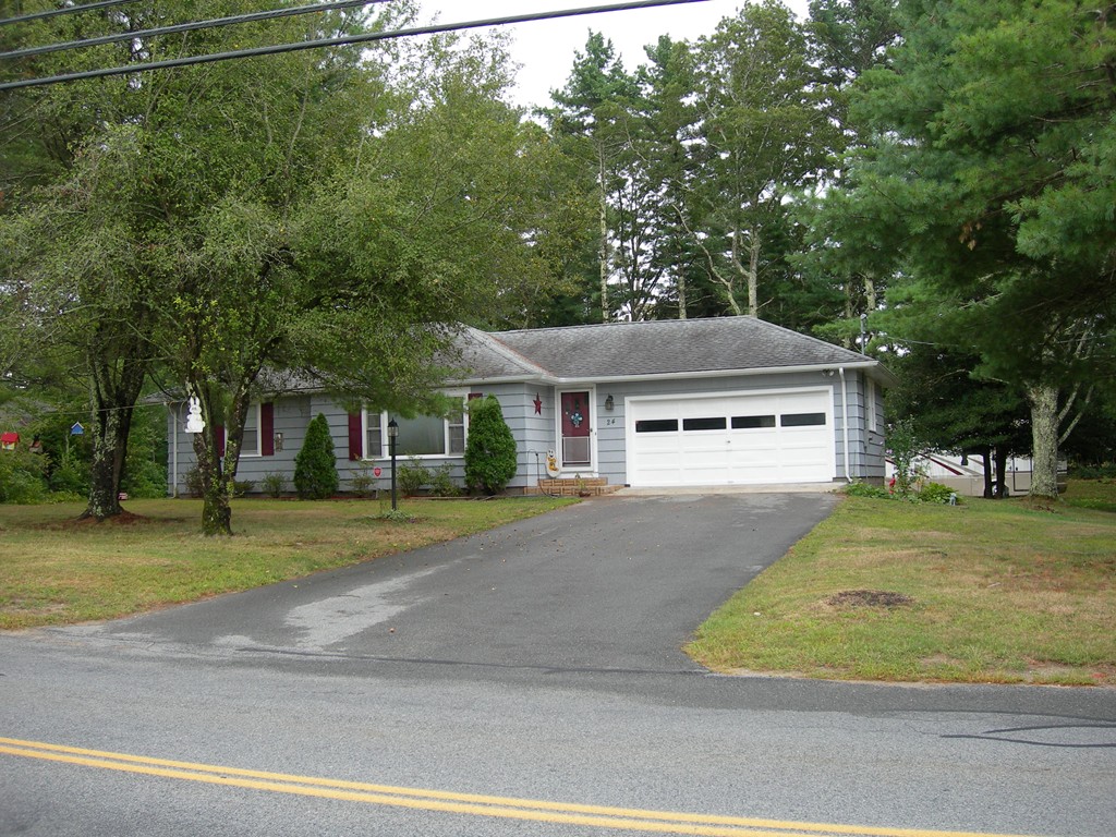 24 Morton Road Freetown, MA 02717 - Photo 2 of 12 a front view of a house with a yard
