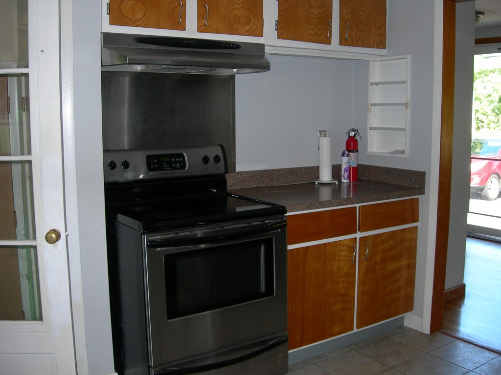 24 Morton Road Freetown, MA 02717 - Photo 7 of 12 a kitchen with a stove and a microwave