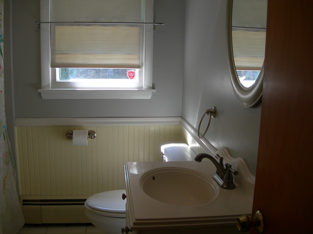 24 Morton Road Freetown, MA 02717 - Photo 8 of 12 a bathroom with a sink a toilet and a mirror