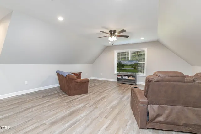 a bedroom with a bed and large windows