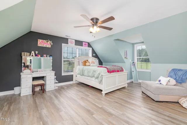 a bed sitting in a bedroom next to a window