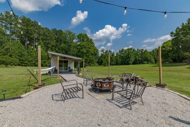 an aerial view of a house with swimming pool garden and outdoor seating