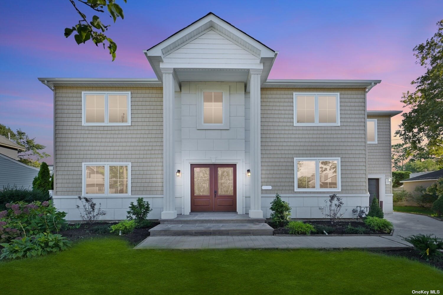 46 Shoreham Road Massapequa, NY 11758 - Photo 1 of 1 a front view of a house with a garden