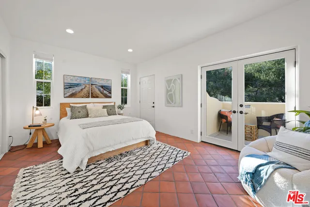 a bedroom with a bed and glass walk in closet