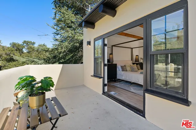 a view of a patio with table and chairs and potted plants