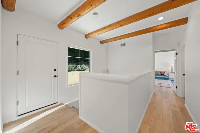 a white building that has a tree on the side of it