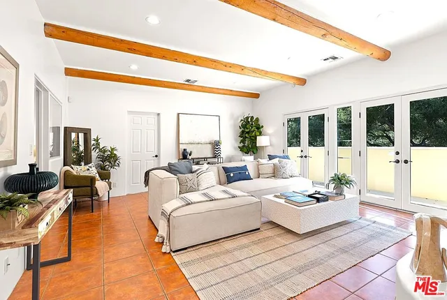 a view of a balcony with chairs and a potted plant