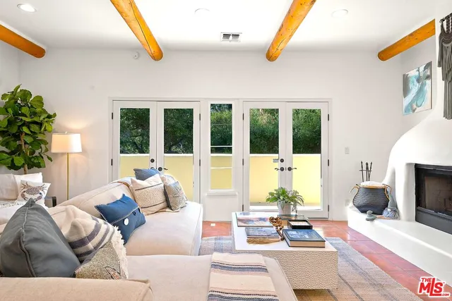 a living room with furniture fireplace and a table