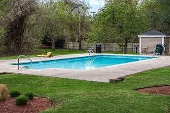 a view of a swimming pool with a yard