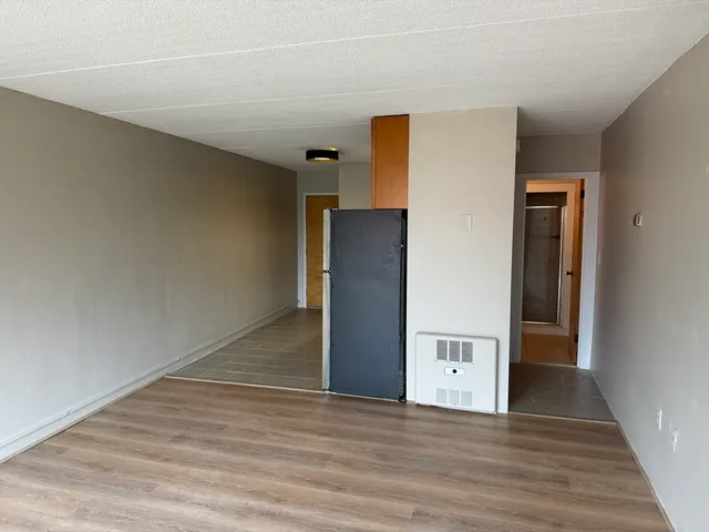 a view of a livingroom with wooden floor and staircase