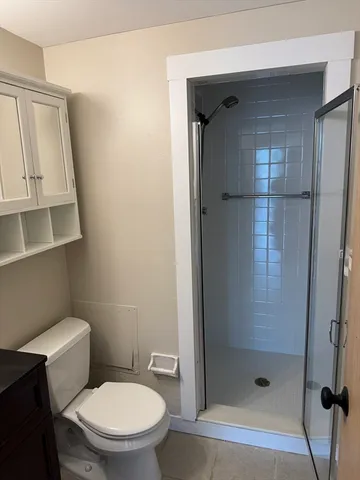 a white toilet sitting next to a bathroom sink