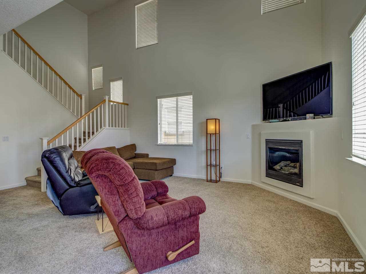 2160 Hellaby Lane Reno, NV 89502 - Photo 2 of 14 a living room with furniture a flat screen tv and a fireplace