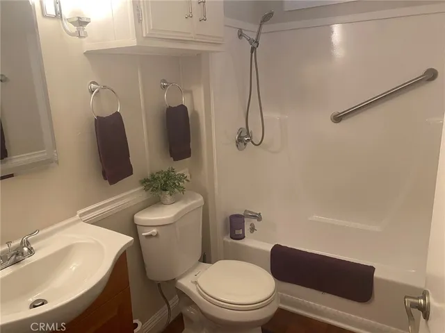a bathroom with a toilet sink and shower