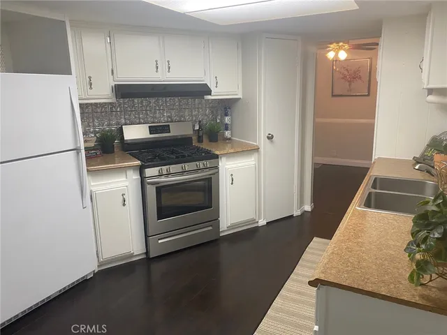 a kitchen with a stove and a refrigerator