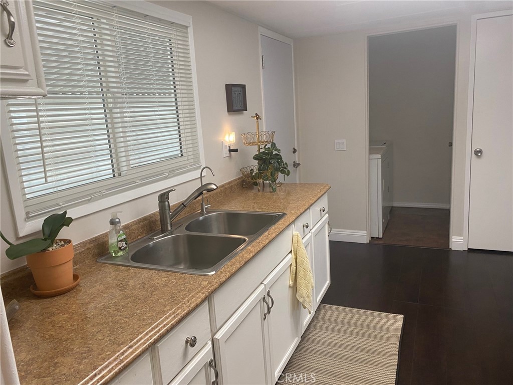 10210 Base Line Road, Unit 289 Alta Loma, CA 91701 - Photo 10 of 25 a kitchen with a sink and wooden floor
