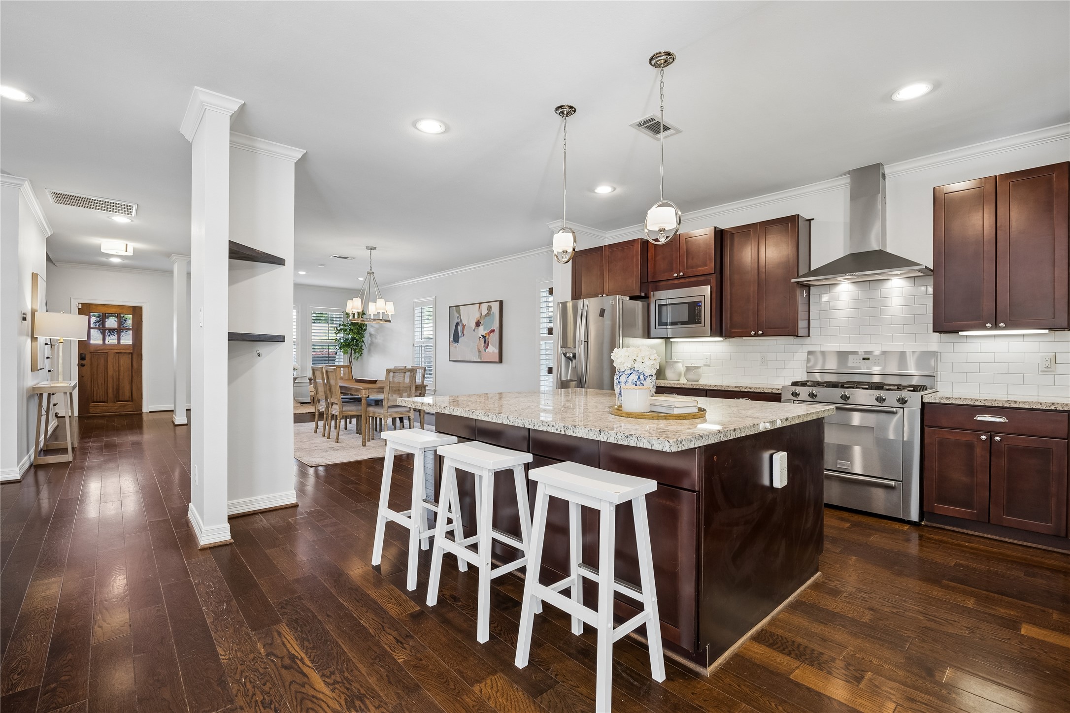 5121 Libbey Drive Houston, TX 77092 - Photo 5 of 24 The kitchen is a culinary dream centered around a massive island that doubles as a social hub with built-in seating and storage. Note the stainless steel appliances which include a gourmet gas range.