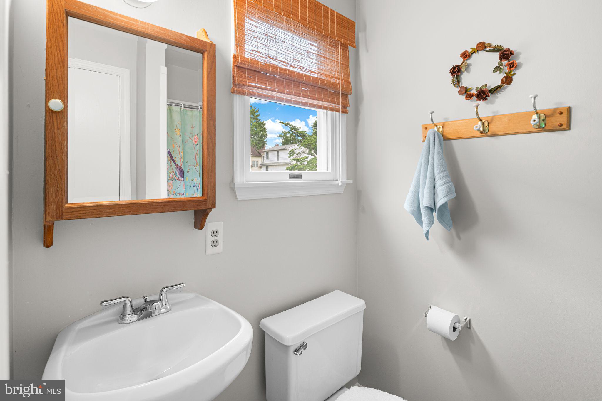 333 South Atlantic Avenue Haddonfield, NJ 08033 - Photo 11 of 19 a bathroom with a sink a mirror and a toilet